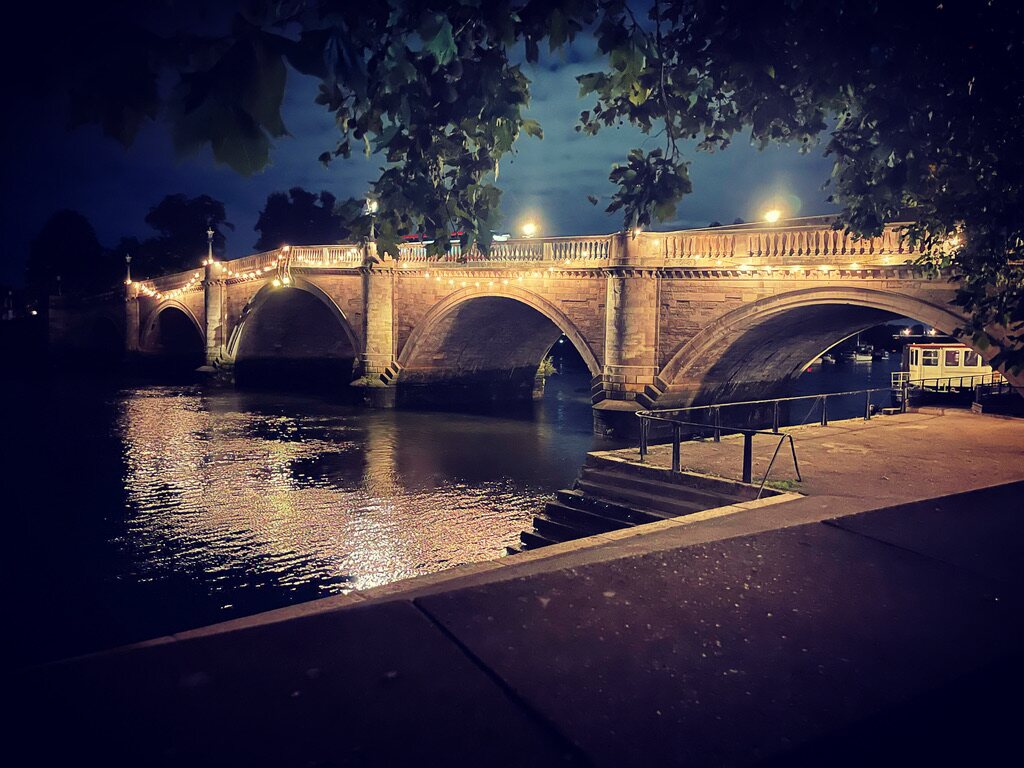 Historic Richmond bridge illuminated over the river at night in London